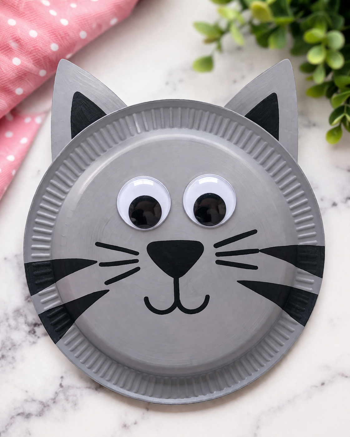 a paper plate colored to look like a cat